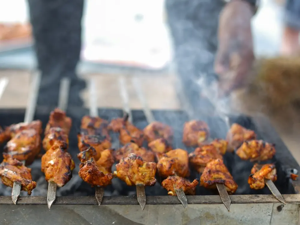 Skewers grilling over charcoal