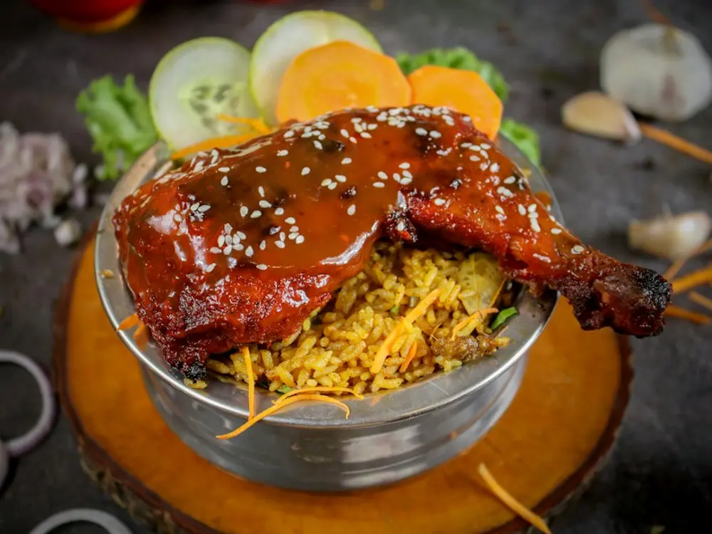 Chicken leg served over spiced rice
